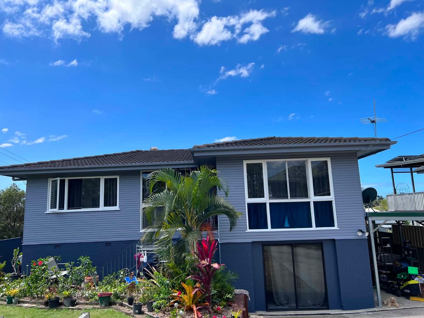 Highset home repainted a modern blue-grey