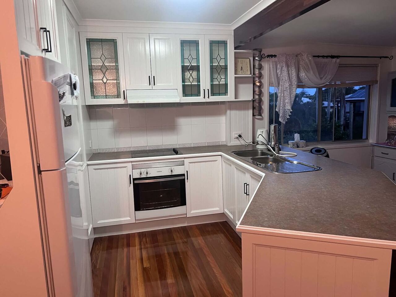 Freshly repainted bright white kitchen in a Brisbane home